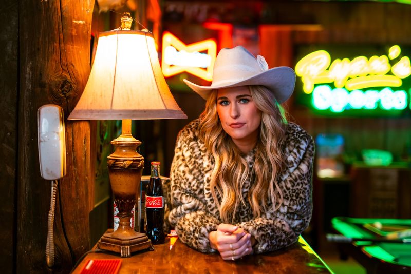 White hat, leopard coat, lamp glow and green neon behind