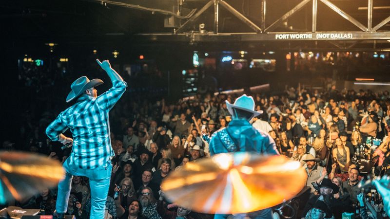 Arm up over a packed Billy Bob's crowd, cymbals glowing