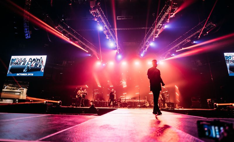 Silhouette strides the runway into exploding red and blue beams